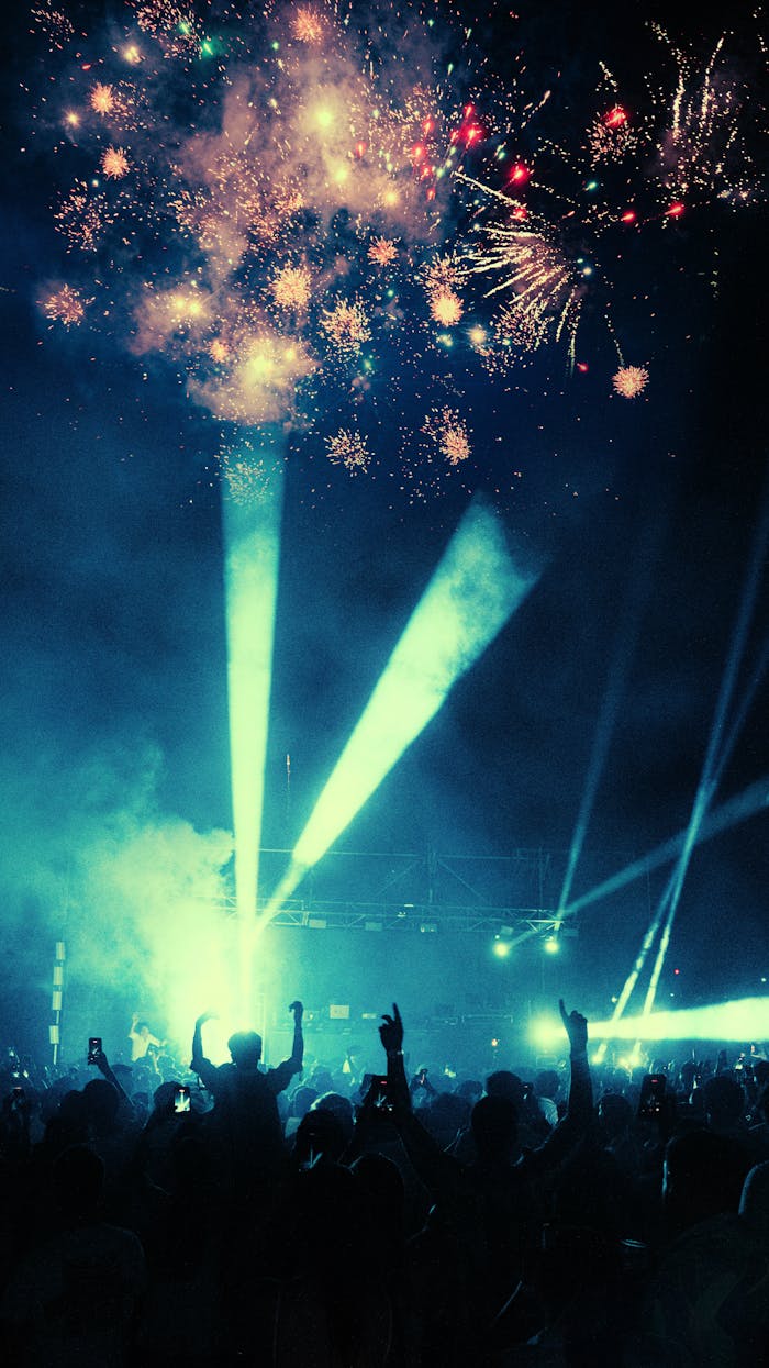 The Art of Drawing Readers In: Your attractive post title goes here Crowd enjoying vibrant fireworks and laser show at night festival.